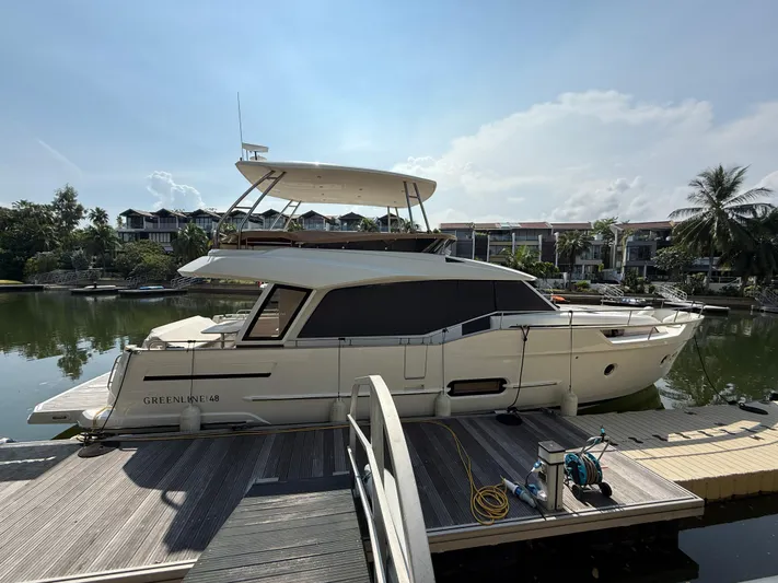 Yacht Photos Pics 2024 Greenline 48 Fly yacht docked at a marina under a clear sky.