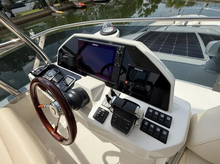  Yacht Photos Pics 2024 Greenline 48 Fly yacht helm with advanced navigation controls and solar panels.