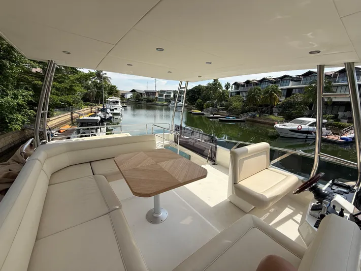  Yacht Photos Pics Luxurious 2024 Greenline 48 Fly yacht interior with spacious seating and scenic waterfront view.