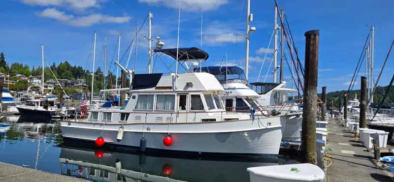 Grand Finale Yacht Photos Pics 1991 Grand Banks 36 Classic yacht docked at a marina, surrounded by other boats.