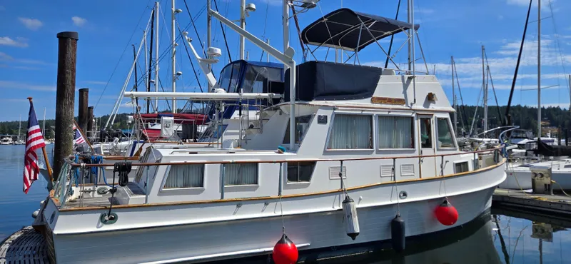 Grand Finale Yacht Photos Pics 1991 Grand Banks 36 Classic yacht docked at marina, featuring elegant design and American flag.