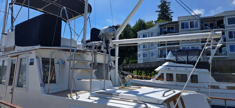 Grand Finale Yacht Photos Pics 1991 Grand Banks 36 Classic yacht docked near waterfront buildings under clear blue sky.