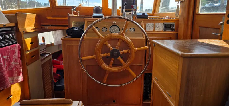 Grand Finale Yacht Photos Pics Interior helm of 1991 Grand Banks 36 Classic yacht with wooden steering wheel and navigation instruments.