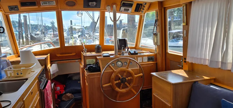 Grand Finale Yacht Photos Pics Interior of 1991 Grand Banks 36 Classic yacht with wooden helm and marina view.