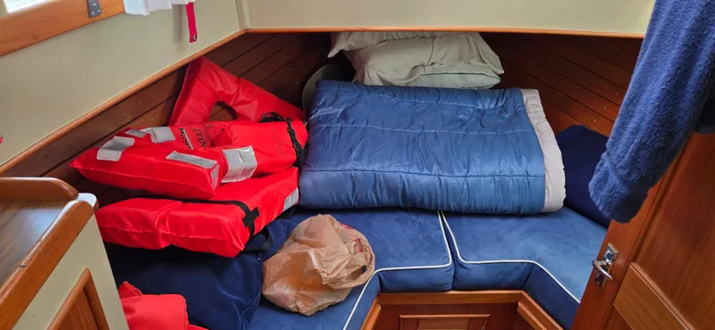 Grand Finale Yacht Photos Pics Cozy cabin interior of 1991 Grand Banks 36 Classic with life jackets and sleeping bag.