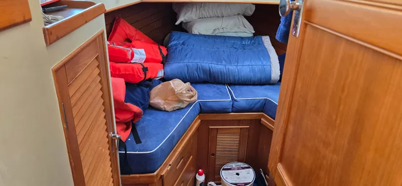 Grand Finale Yacht Photos Pics Cozy cabin interior of 1991 Grand Banks 36 Classic with life jackets and bedding.