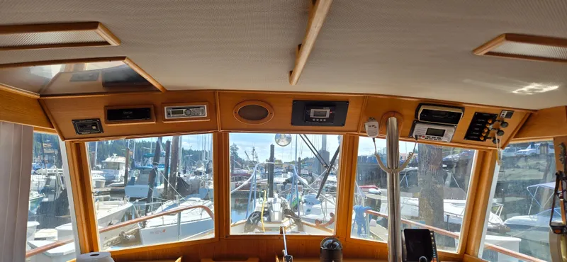 Grand Finale Yacht Photos Pics Interior view of a 1991 Grand Banks 36 Classic yacht, showcasing the helm and marina.