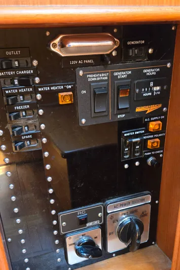 Grand Finale Yacht Photos Pics Control panel of a 1991 Grand Banks 36 Classic boat, featuring generator and power switches.