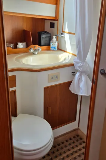 Grand Finale Yacht Photos Pics Bathroom interior of 1991 Grand Banks 36 Classic yacht, featuring sink and toilet.