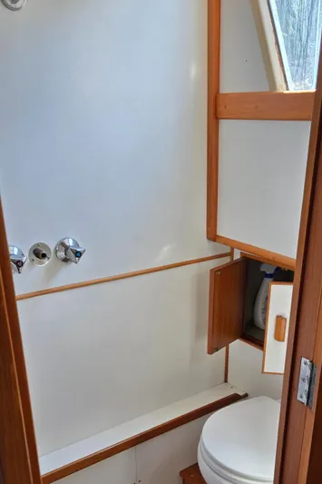 Grand Finale Yacht Photos Pics Bathroom interior of 1991 Grand Banks 36 Classic yacht, featuring wooden accents and compact design.