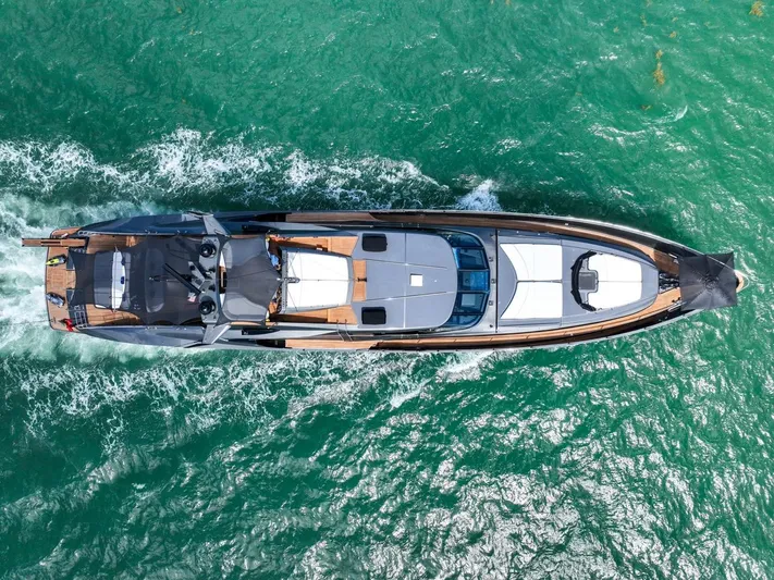  Yacht Photos Pics Aerial view of 2003 Palmer Johnson 120 yacht cruising on turquoise waters.