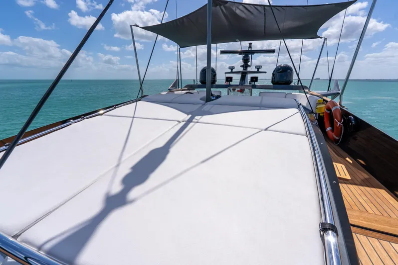  Yacht Photos Pics Luxury Palmer Johnson 120 yacht deck with sunshade, 2003 model, on serene ocean waters.