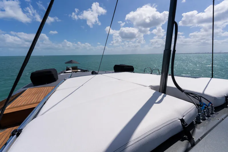  Yacht Photos Pics Luxurious Palmer Johnson 120 yacht deck with sunbathing area, ocean view, and clear blue sky.