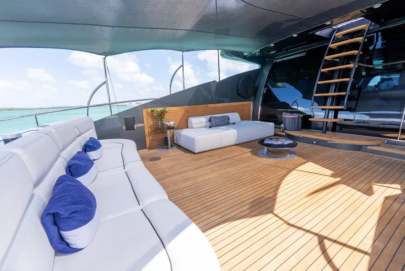  Yacht Photos Pics Luxurious Palmer Johnson 120 yacht deck with elegant seating, wooden flooring, and ocean view.