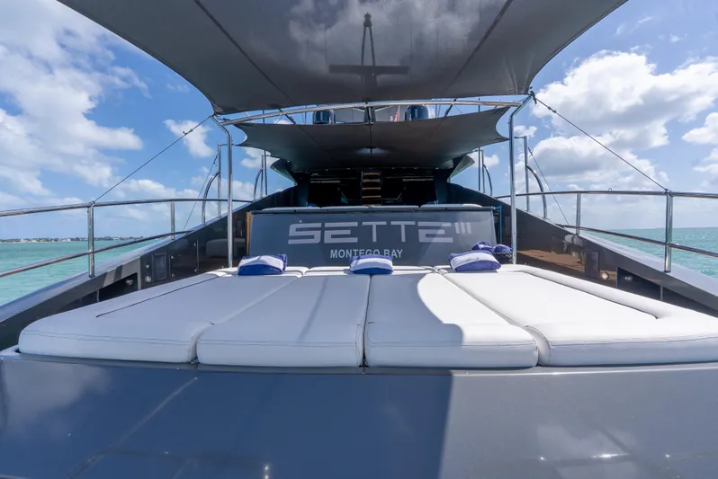  Yacht Photos Pics Luxurious Palmer Johnson 120 yacht deck with sunbeds, 2003 model, under a clear blue sky.