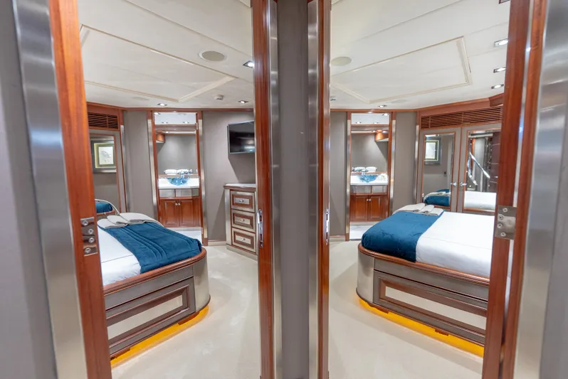  Yacht Photos Pics Luxurious interior of a 2003 Palmer Johnson 120 yacht with elegant wood finishes and cozy bedding.