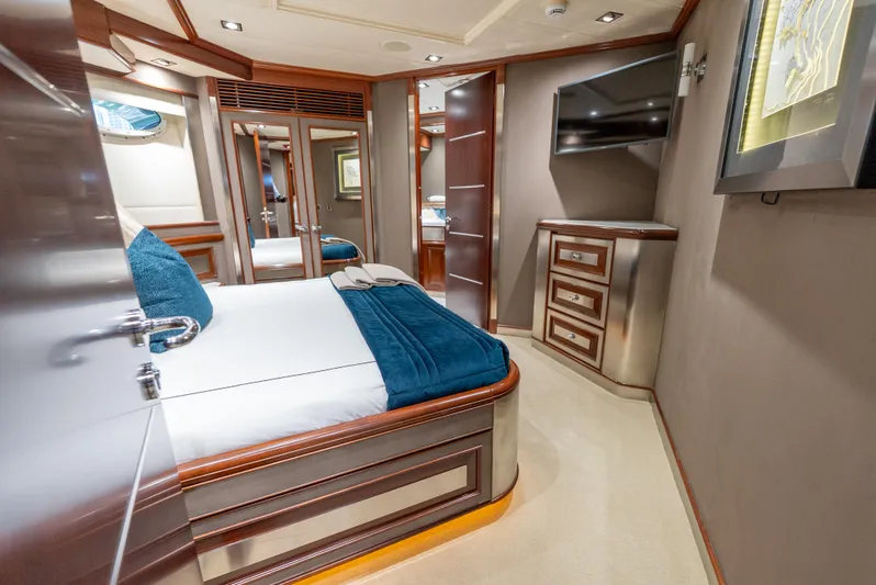  Yacht Photos Pics Luxurious bedroom interior of 2003 Palmer Johnson 120 yacht with modern furnishings and elegant decor.