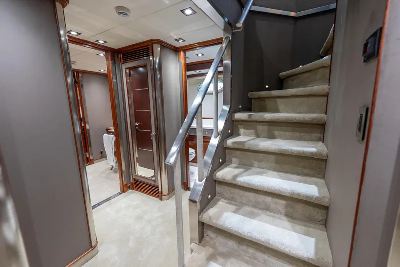 Yacht Photos Pics Luxurious interior of 2003 Palmer Johnson 120 yacht with carpeted stairs and elegant wood finishes.