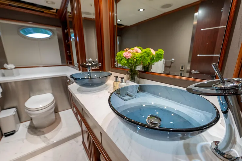  Yacht Photos Pics Luxurious yacht bathroom with dual glass sinks, elegant fixtures, and floral decor on Palmer Johnson 120.