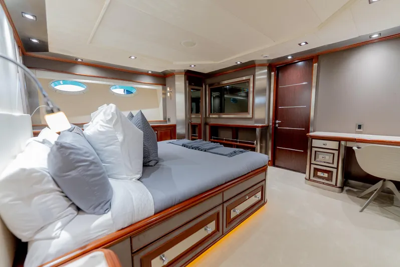  Yacht Photos Pics Luxurious bedroom interior of 2003 Palmer Johnson 120 yacht with elegant wood finishes and modern decor.