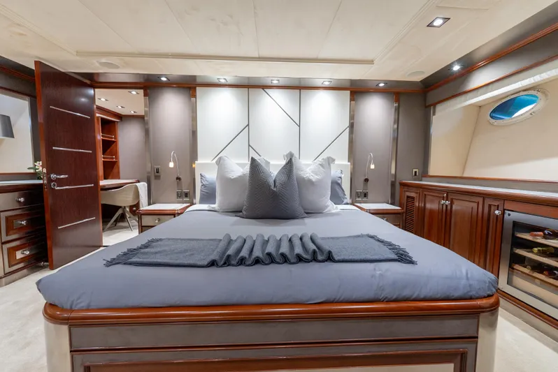  Yacht Photos Pics Luxurious bedroom interior on a 2003 Palmer Johnson 120 yacht, featuring elegant wood finishes.