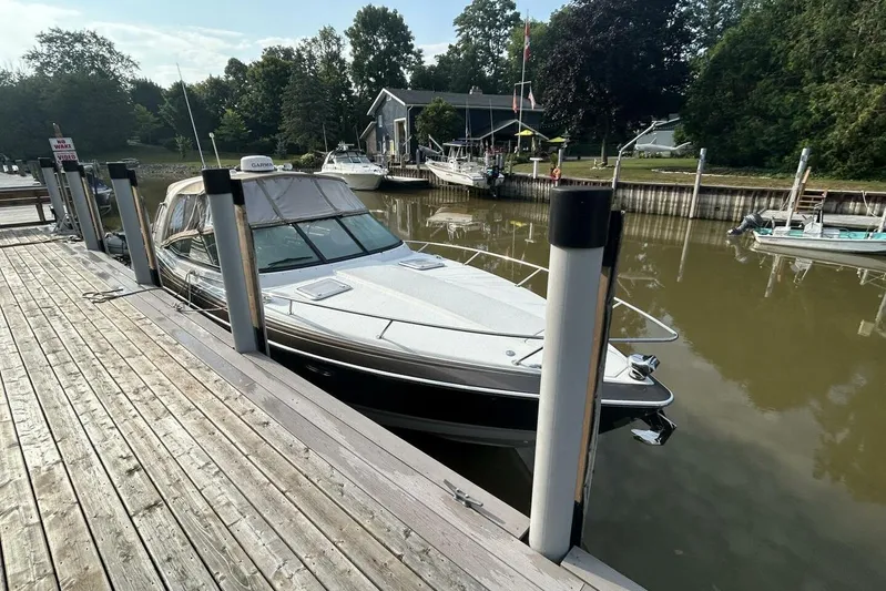  Yacht Photos Pics 2016 Formula 350 Sunsport docked at a serene marina with lush greenery.