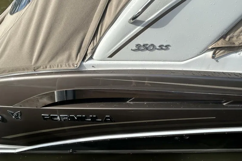  Yacht Photos Pics 2016 Formula 350 Sunsport boat with beige cover and sleek design details.