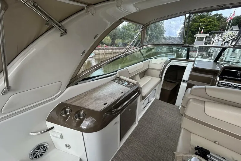  Yacht Photos Pics 2016 Formula 350 Sunsport boat interior with seating and helm, docked by a river.