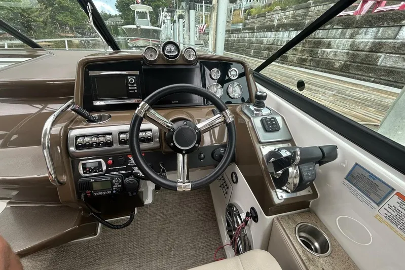  Yacht Photos Pics Cockpit of a 2016 Formula 350 Sunsport boat with steering wheel and control panel.