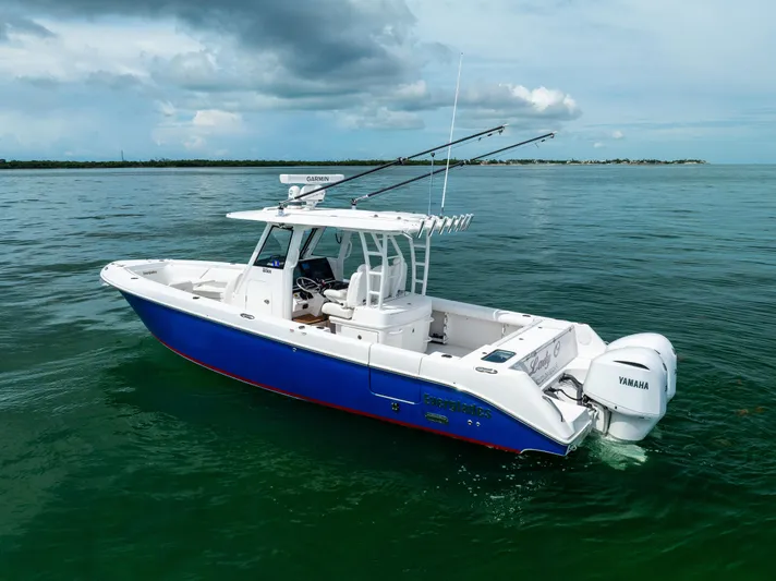 Yacht Photos Pics 2019 Everglades 335 Center Console boat on calm water with fishing rods.