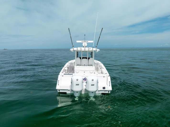  Yacht Photos Pics 2019 Everglades 335 Center Console boat on open water, rear view.