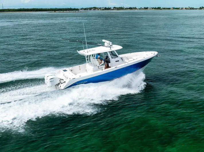  Yacht Photos Pics 2019 Everglades 335 Center Console boat cruising on open water.