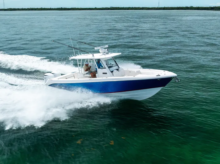  Yacht Photos Pics 2019 Everglades 335 Center Console boat cruising on open water.