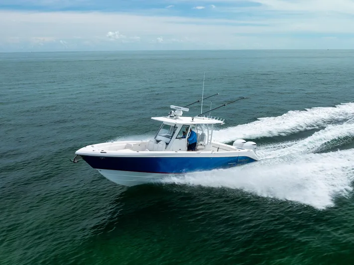  Yacht Photos Pics 2019 Everglades 335 Center Console boat cruising on open water.