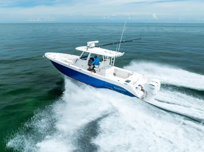 Yacht Photos Pics 2019 Everglades 335 Center Console boat speeding on open water.