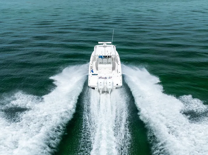 Yacht Photos Pics 2019 Everglades 335 Center Console boat cruising on open water.