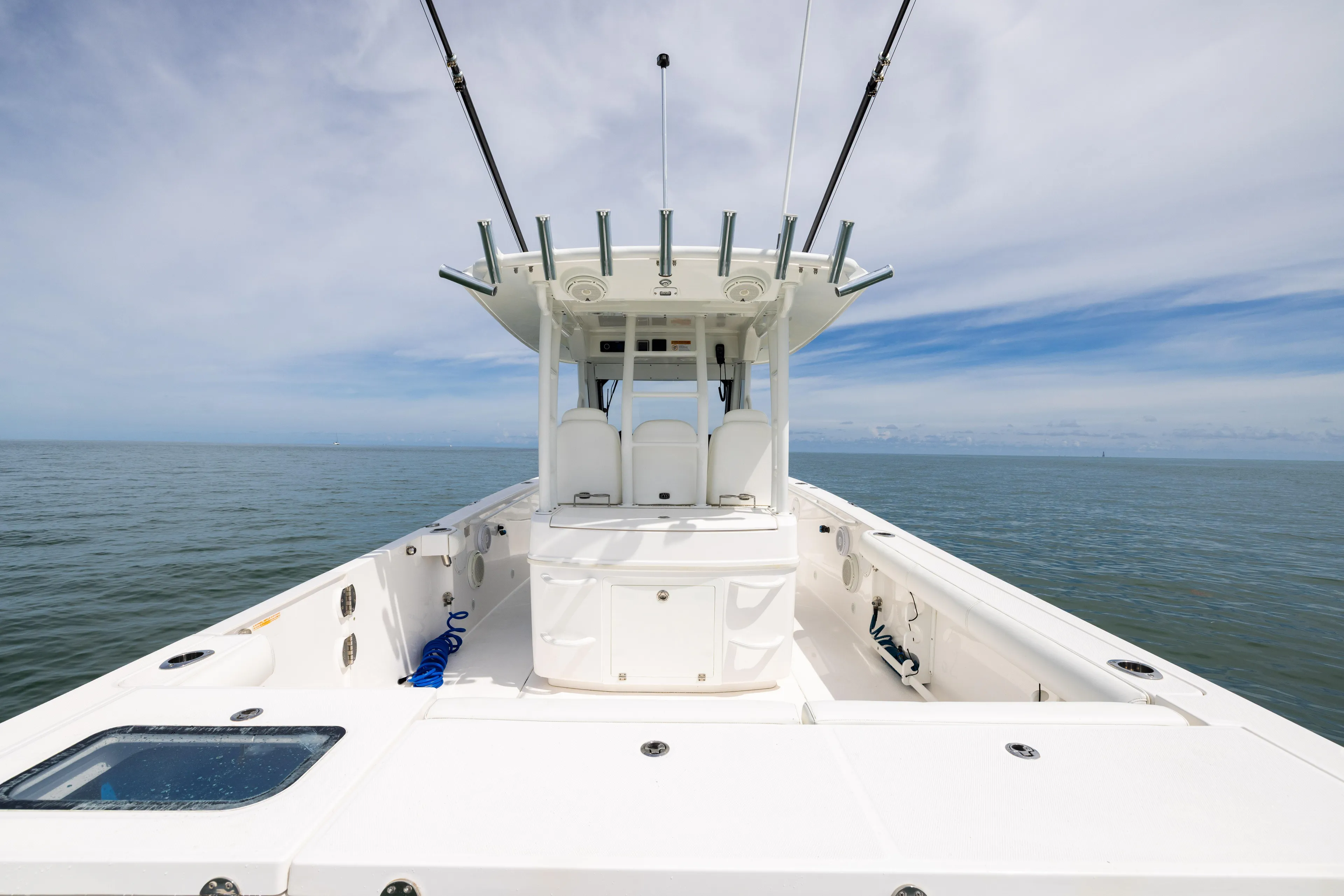 Yacht Photos Pics 2019 Everglades 335 Center Console boat on open water, showcasing spacious deck and fishing rods.