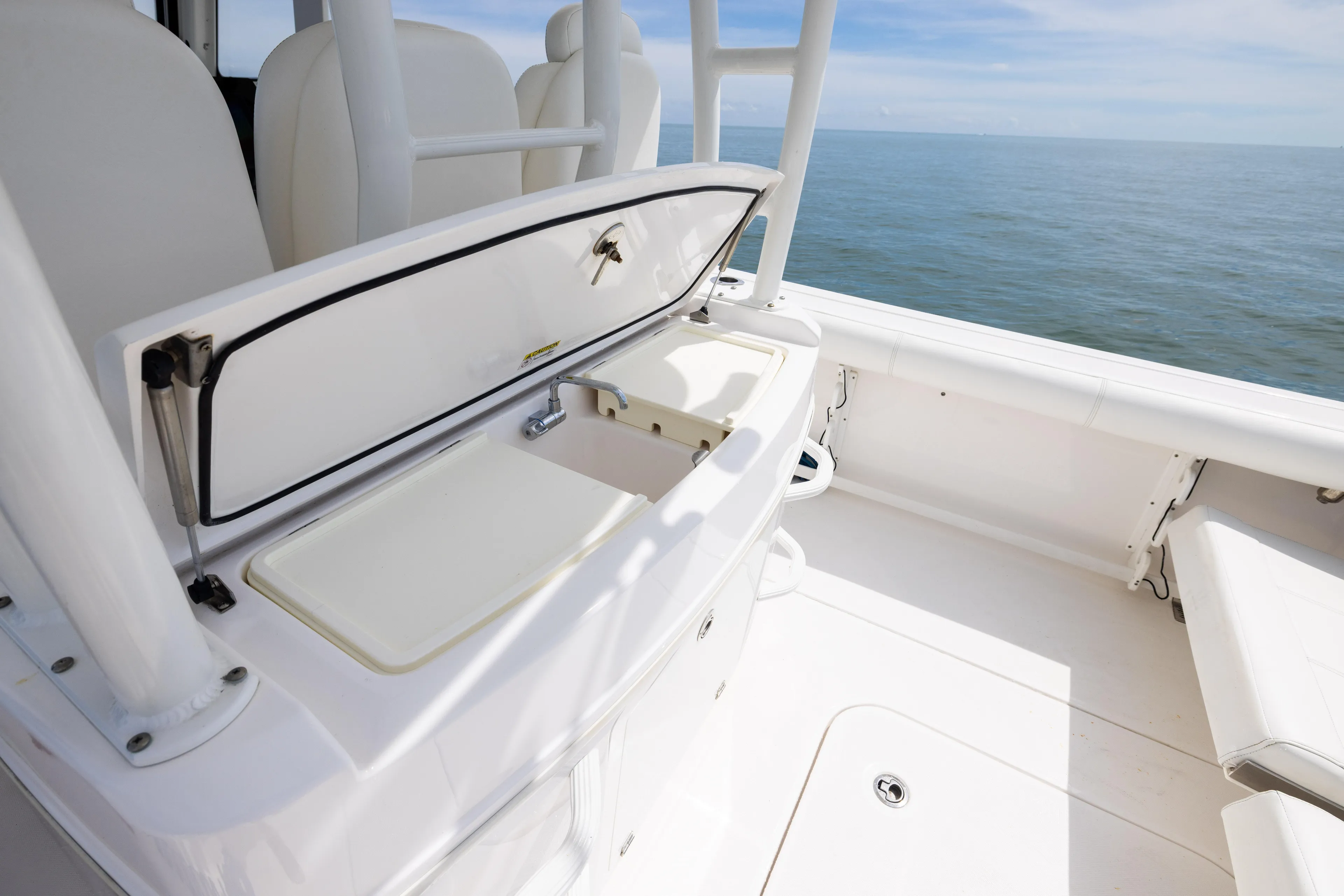  Yacht Photos Pics 2019 Everglades 335 Center Console boat with open storage compartment, ocean view.