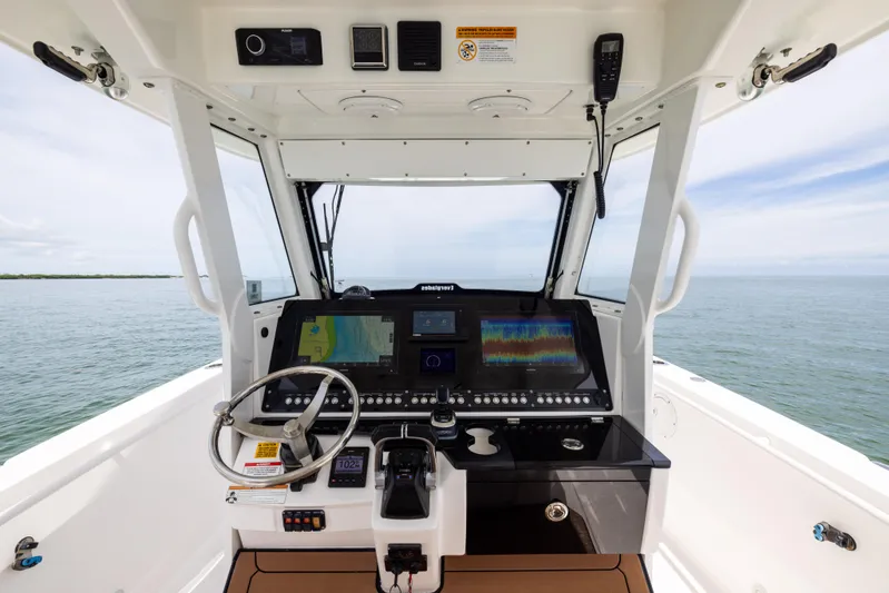  Yacht Photos Pics 2019 Everglades 335 Center Console helm with advanced navigation displays on open water.