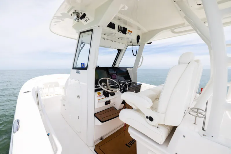  Yacht Photos Pics 2019 Everglades 335 Center Console boat interior with helm and seating, on open water.