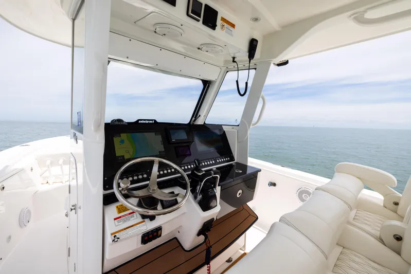  Yacht Photos Pics 2019 Everglades 335 Center Console boat interior with navigation system and ocean view.