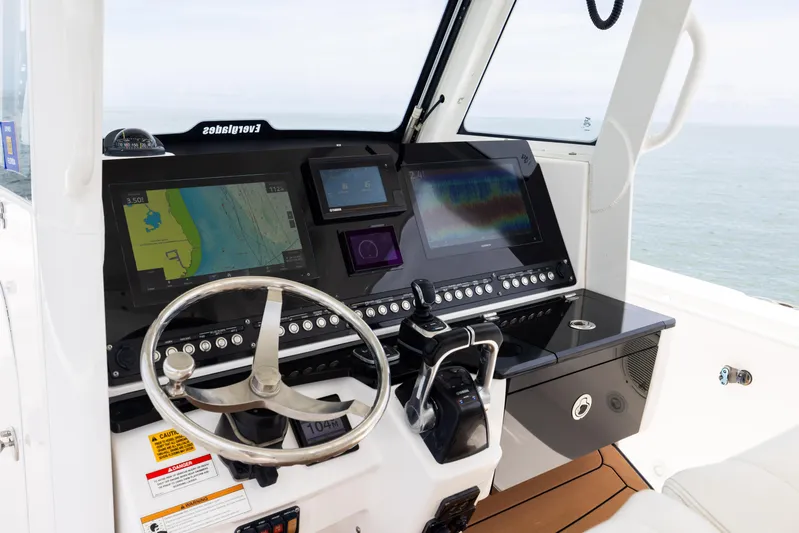  Yacht Photos Pics 2019 Everglades 335 Center Console helm with navigation screens and steering wheel.