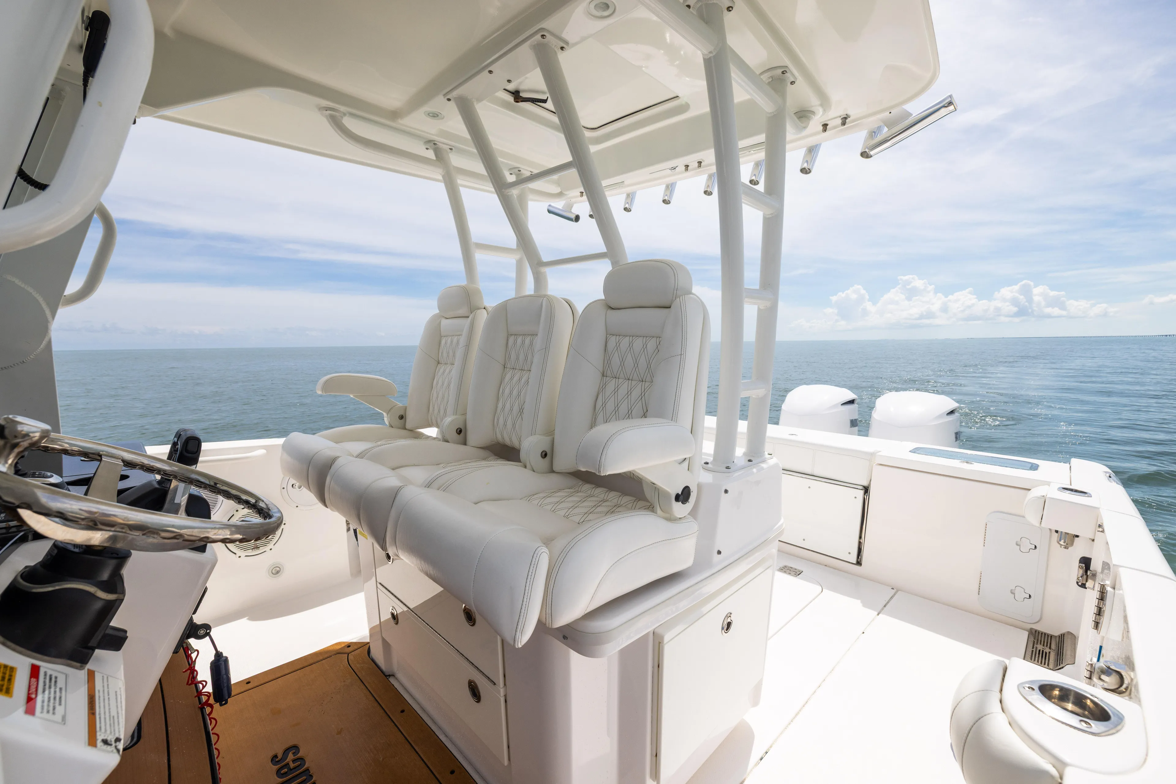  Yacht Photos Pics 2019 Everglades 335 Center Console boat interior with white seating and ocean view.