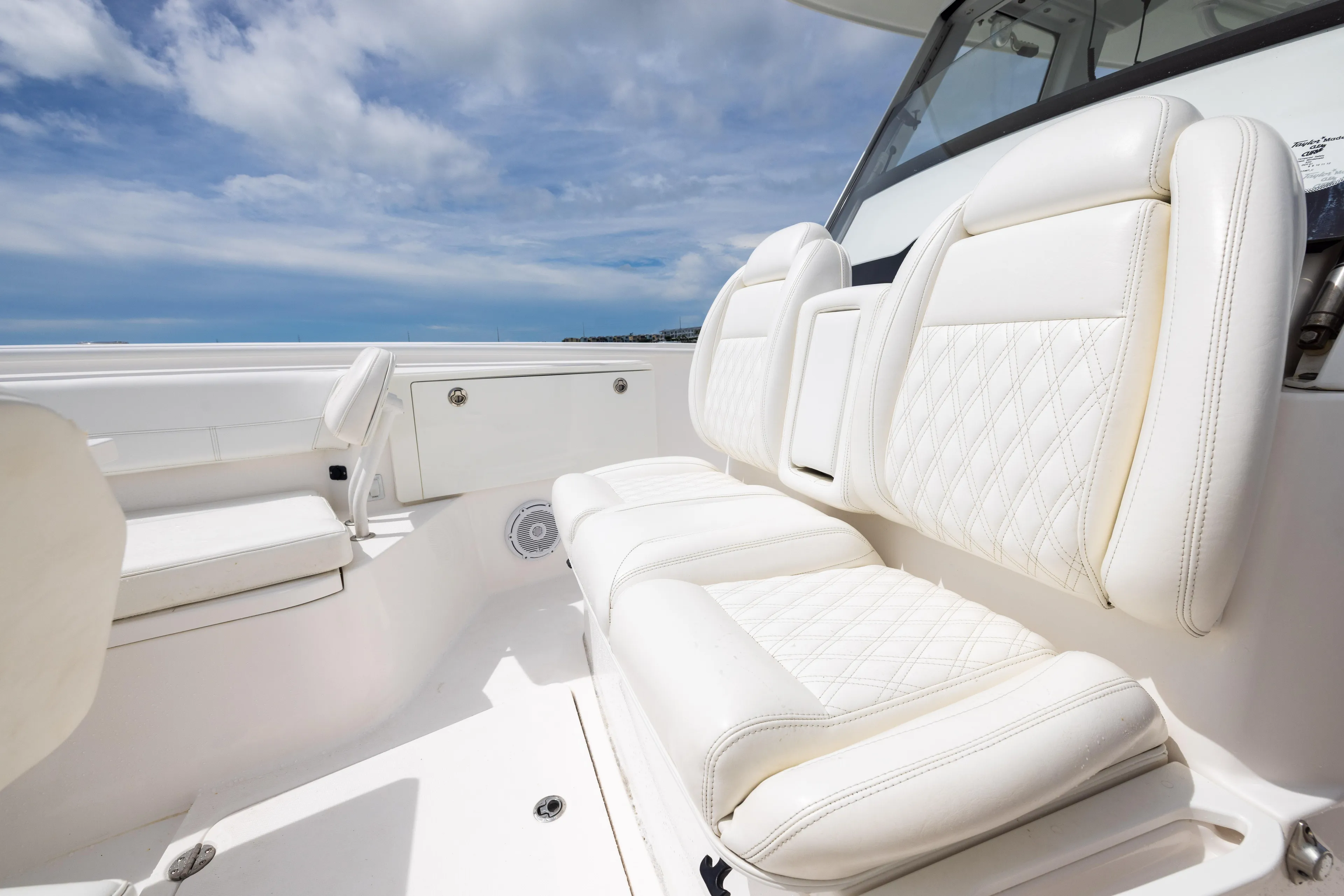  Yacht Photos Pics 2019 Everglades 335 Center Console boat with luxurious white seating under a blue sky.