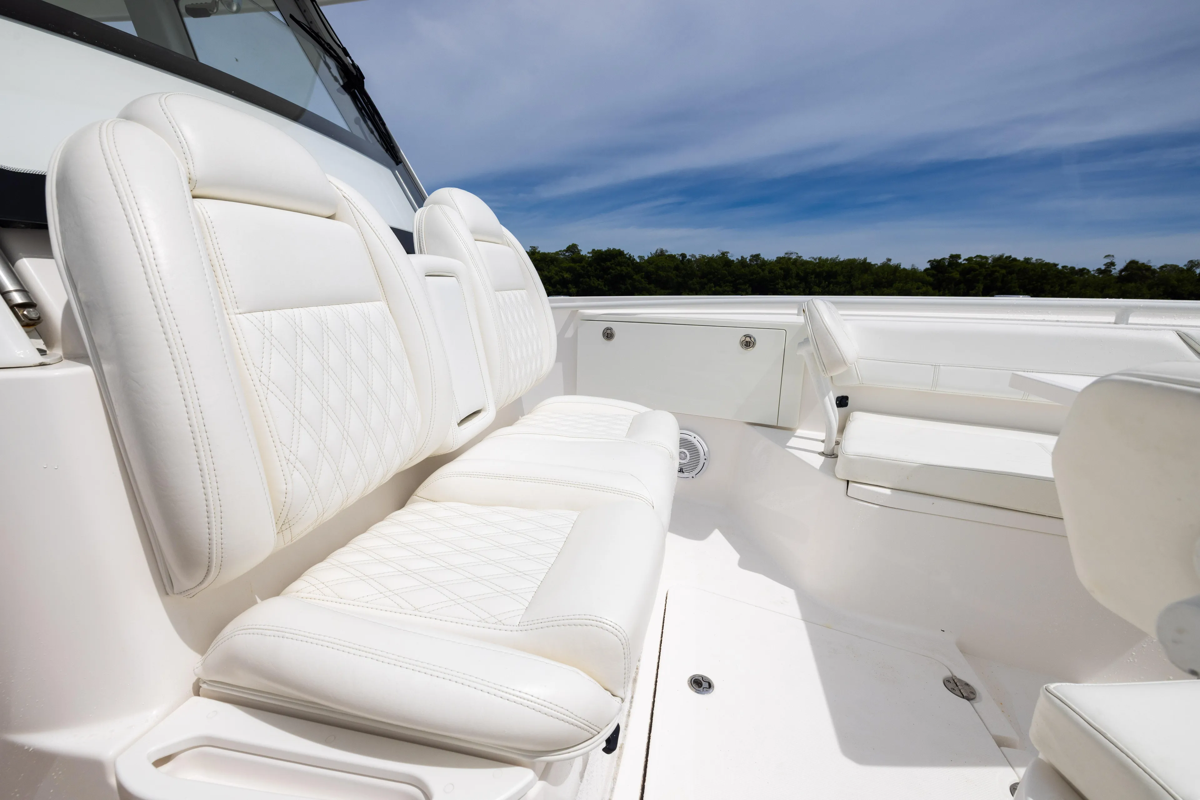  Yacht Photos Pics Luxurious seating on 2019 Everglades 335 Center Console boat under clear blue sky.