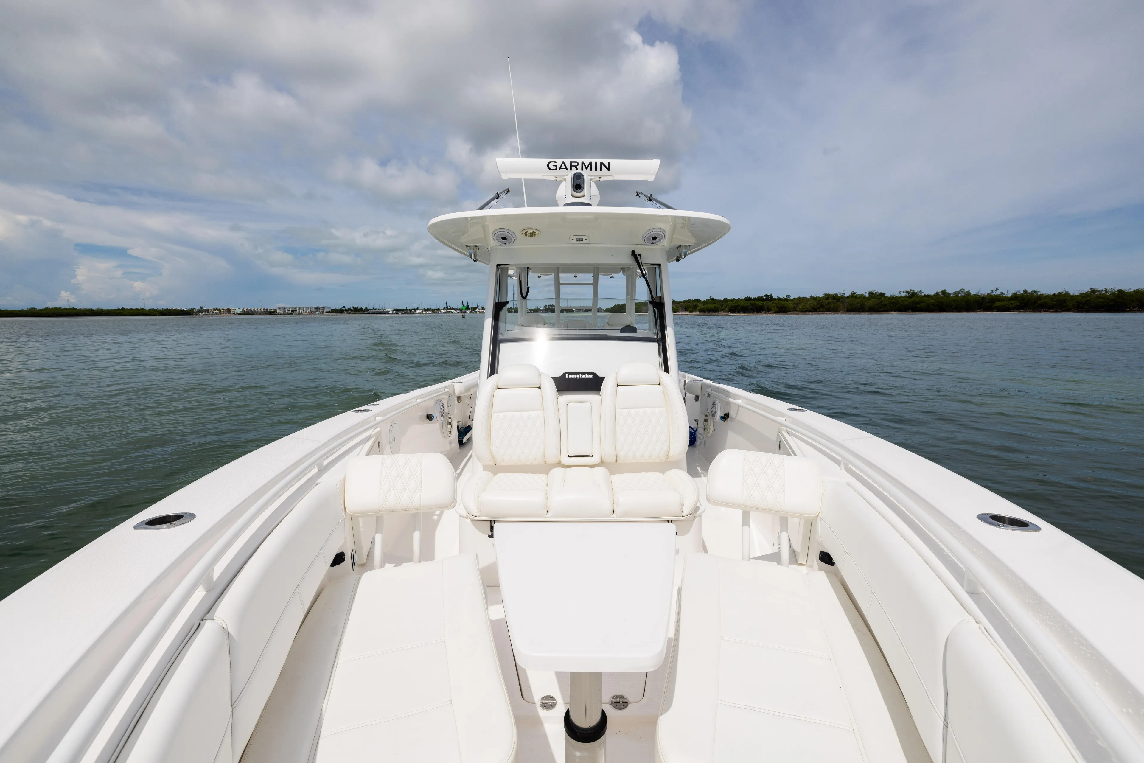  Yacht Photos Pics 2019 Everglades 335 Center Console boat on calm water, featuring spacious seating and Garmin equipment.