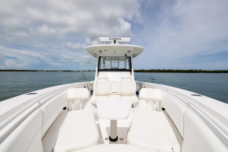  Yacht Photos Pics 2019 Everglades 335 Center Console boat on calm water under cloudy sky.