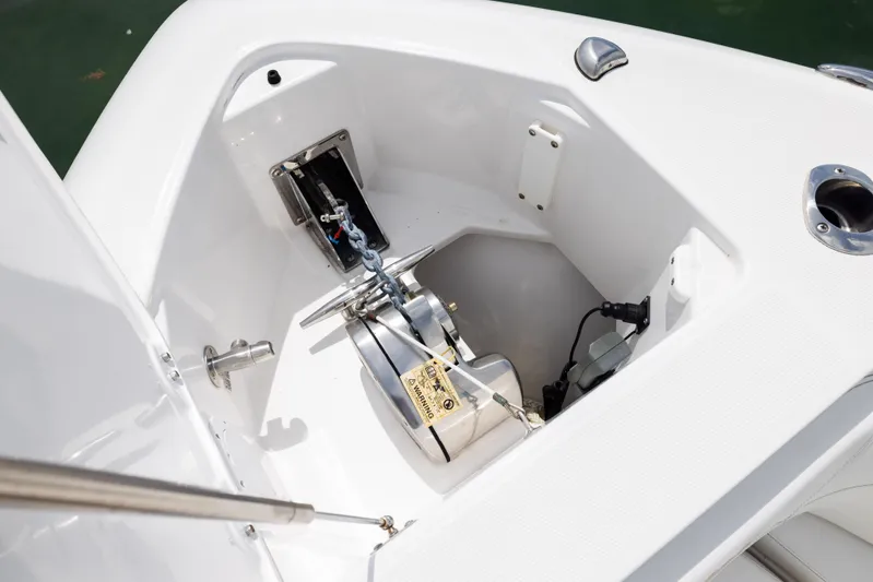  Yacht Photos Pics Anchor compartment of 2019 Everglades 335 Center Console boat, featuring a winch and chain.