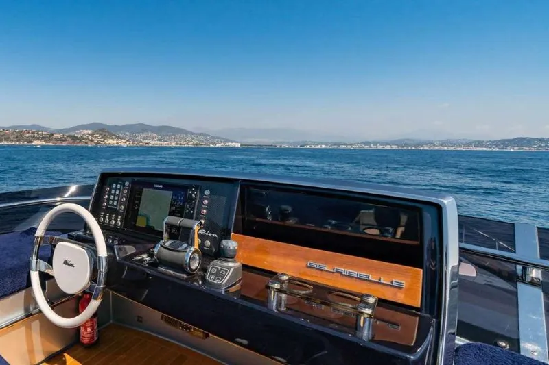  Yacht Photos Pics Cockpit view of 2019 Riva 66 RIBELLE yacht with ocean and coastline in background.