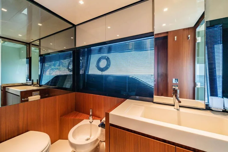  Yacht Photos Pics Luxurious bathroom interior of 2019 Riva 66 RIBELLE yacht with modern fixtures and wood accents.